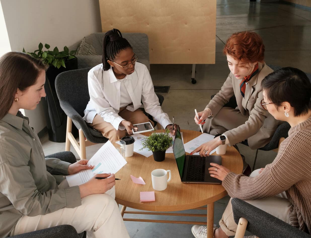 Team collaborating in a modern office setting around a coffee table